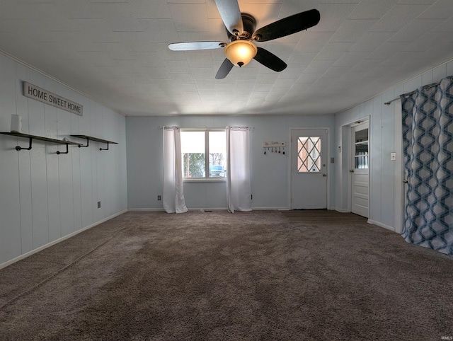 unfurnished living room featuring a ceiling fan and carpet floors