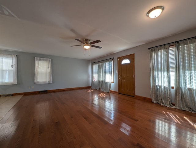 foyer featuring visible vents, baseboards, and hardwood / wood-style floors