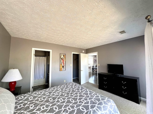 bedroom featuring visible vents and a textured ceiling