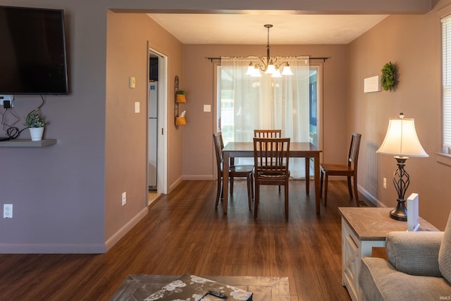 dining space with dark wood-style floors, baseboards, and a chandelier