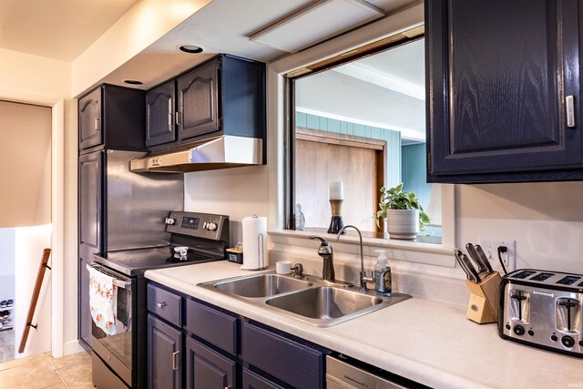 kitchen with under cabinet range hood, a sink, stainless steel range with electric cooktop, light tile patterned flooring, and light countertops