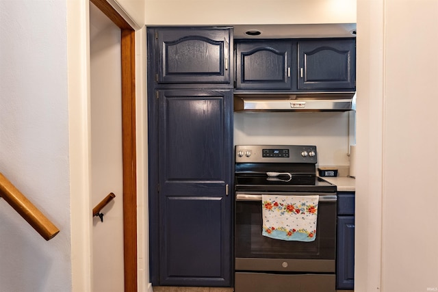 kitchen with under cabinet range hood, light countertops, and electric stove