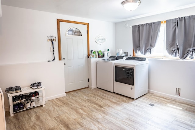 laundry room featuring laundry area, baseboards, and washer and clothes dryer