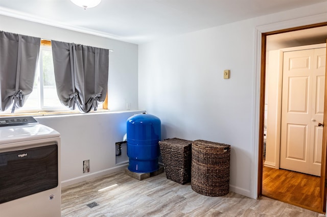 misc room featuring washer / dryer, wood finished floors, and baseboards