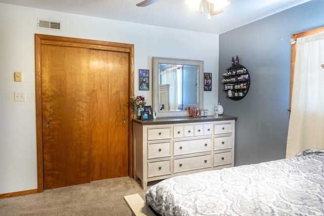 bedroom featuring baseboards, a ceiling fan, visible vents, and light carpet