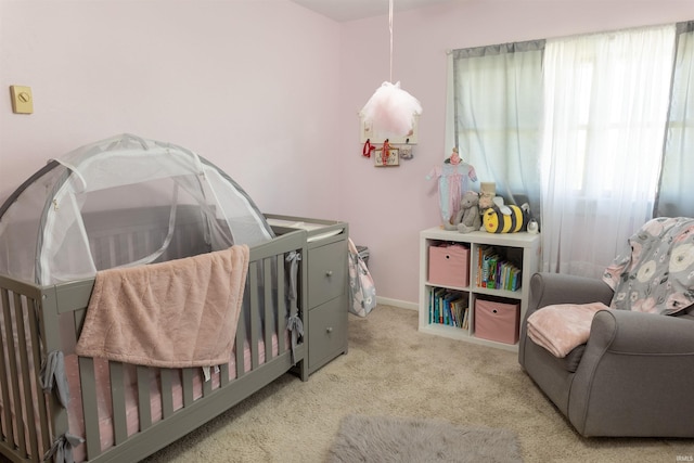 carpeted bedroom featuring baseboards