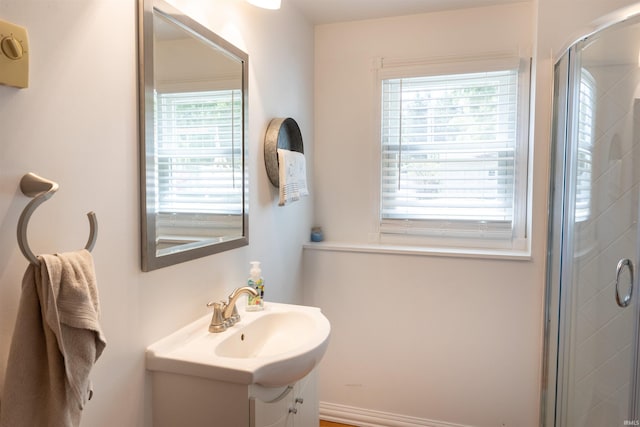 bathroom featuring a shower stall and vanity