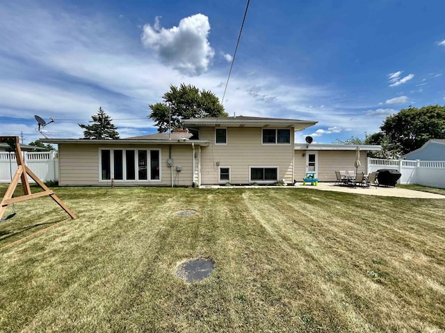 back of property featuring a patio area, fence, and a lawn