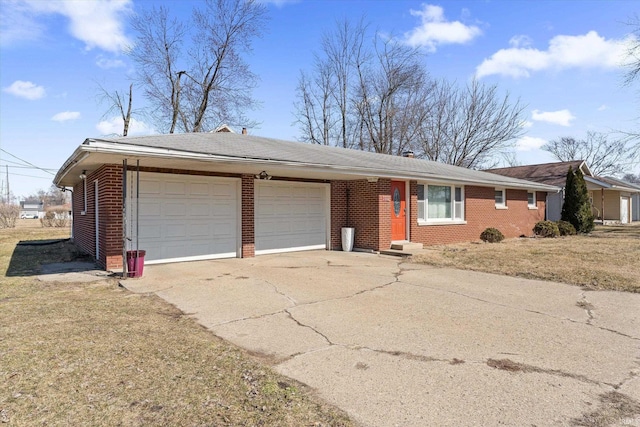 single story home with brick siding, an attached garage, driveway, and a front lawn