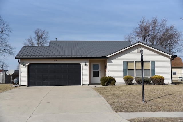 ranch-style home featuring metal roof, concrete driveway, and an attached garage