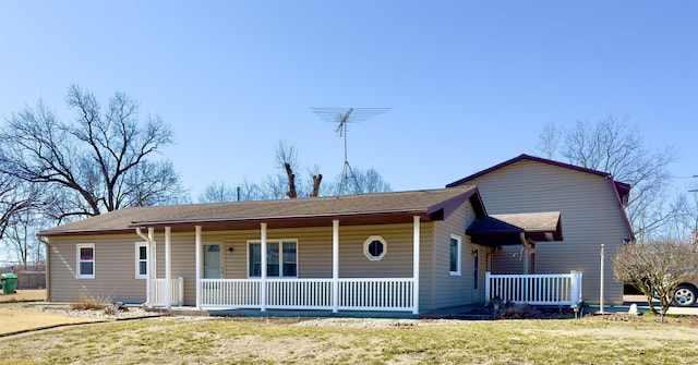 view of front of property with a porch and a front yard