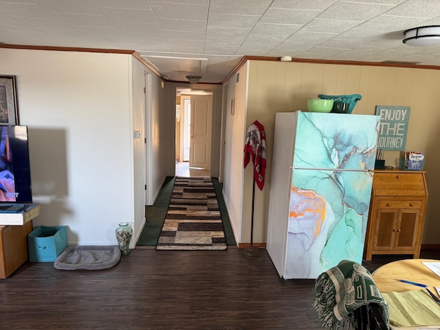 hall featuring wood finished floors and ornamental molding