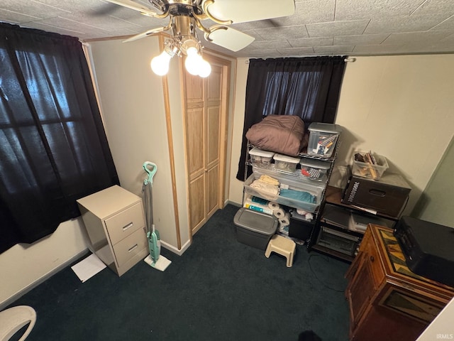 carpeted bedroom with baseboards and ceiling fan