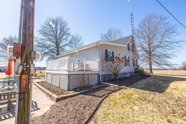 view of side of property with a wooden deck