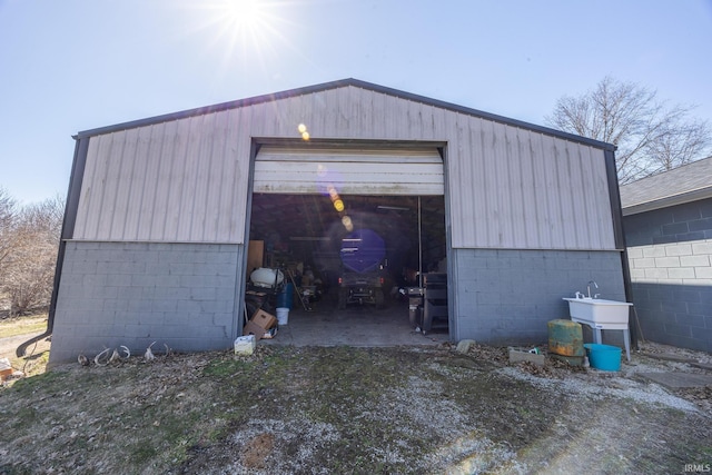 detached garage with a sink and driveway