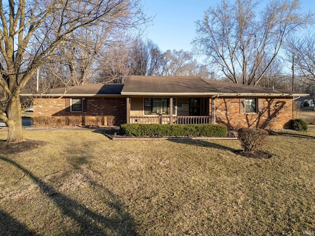 single story home with brick siding, a porch, and a front yard