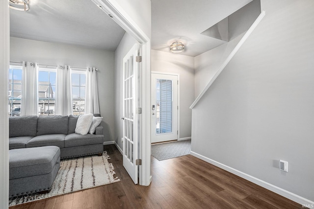 living area with baseboards and dark wood finished floors