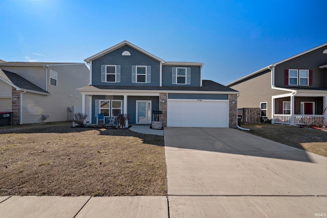 traditional-style home with an attached garage, covered porch, and driveway