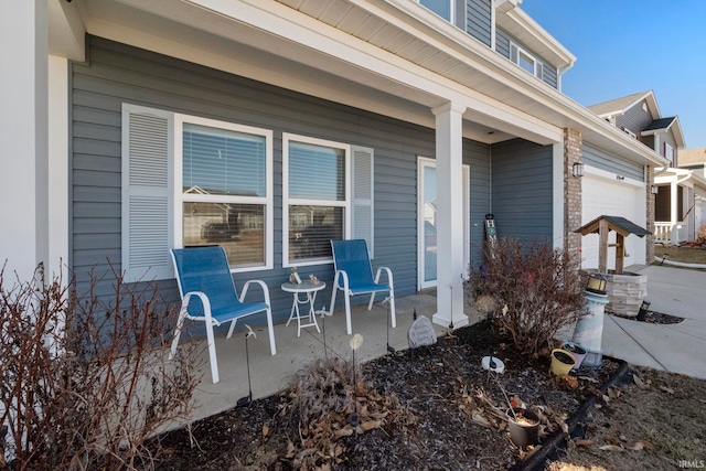 view of patio featuring a garage and covered porch