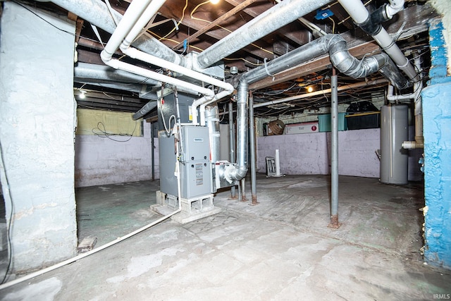 unfinished basement featuring gas water heater and heating unit