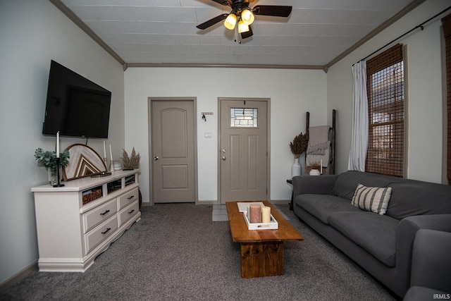 carpeted living room with baseboards, crown molding, and a ceiling fan