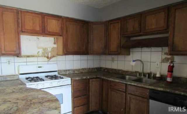 kitchen featuring a sink, decorative backsplash, stainless steel dishwasher, and white gas stove