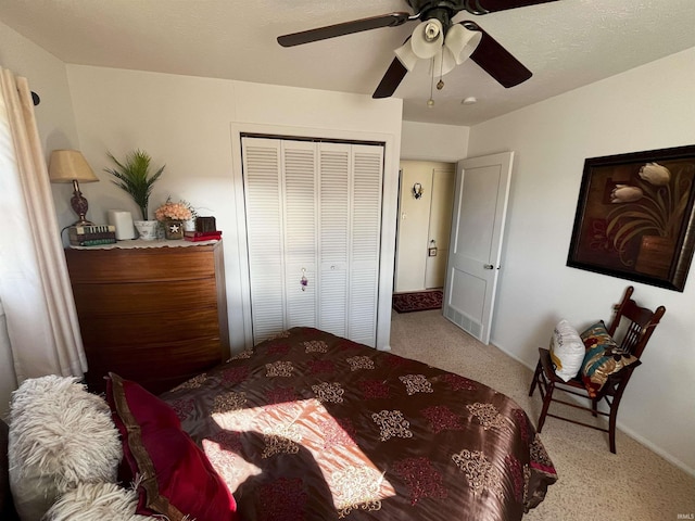 carpeted bedroom with a closet, baseboards, and ceiling fan