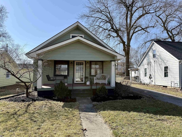 bungalow-style home with a porch and a front lawn