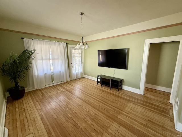 interior space with baseboards and wood-type flooring