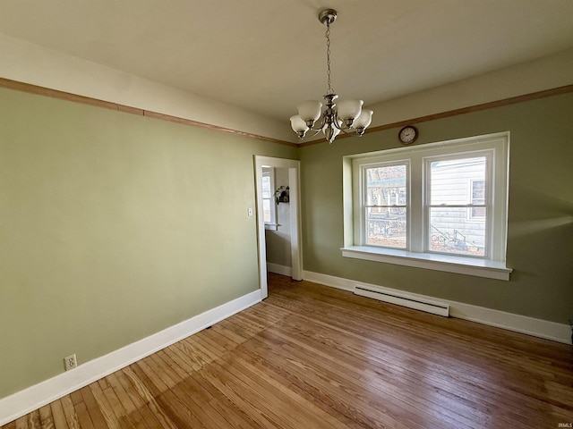 unfurnished dining area featuring baseboards, baseboard heating, an inviting chandelier, and hardwood / wood-style flooring