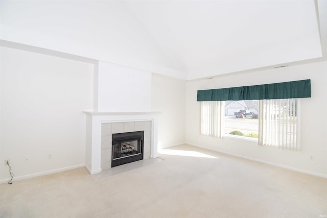 unfurnished living room with high vaulted ceiling, baseboards, carpet, and a tiled fireplace