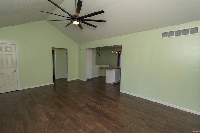 unfurnished living room with visible vents, dark wood-style floors, baseboards, lofted ceiling, and ceiling fan