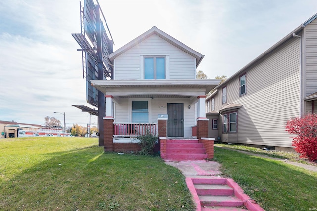 view of front of home with covered porch and a front yard