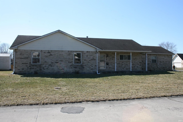 single story home with brick siding, covered porch, and a front lawn