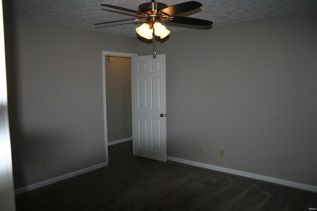 carpeted empty room featuring baseboards, a textured ceiling, and ceiling fan