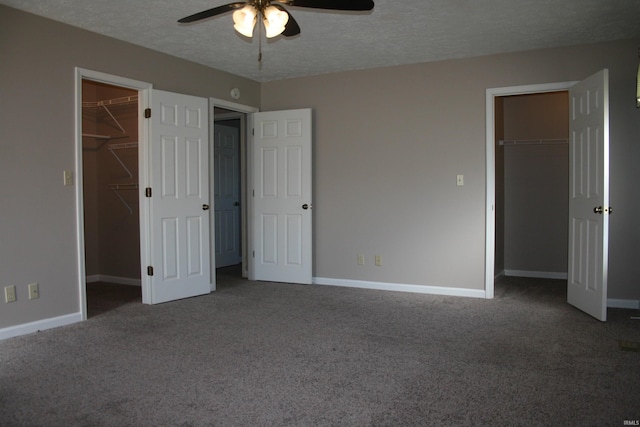 unfurnished bedroom with a closet, carpet flooring, and a walk in closet