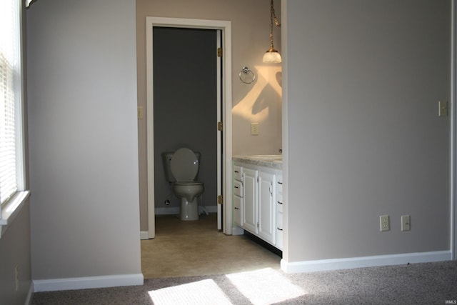 unfurnished bedroom featuring light carpet and baseboards