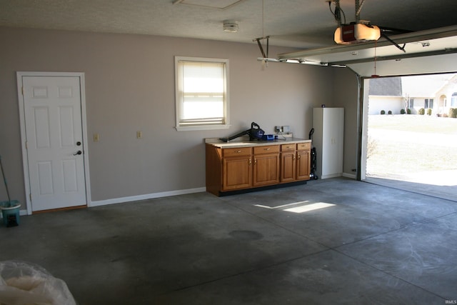 garage featuring baseboards and a garage door opener