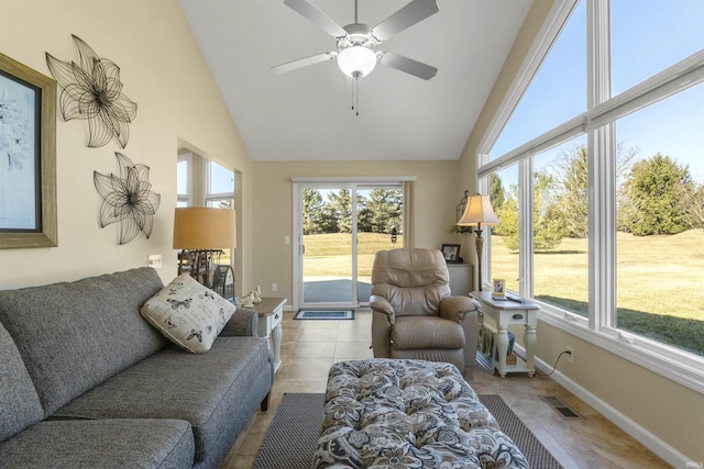 tiled living area with visible vents, baseboards, high vaulted ceiling, and ceiling fan