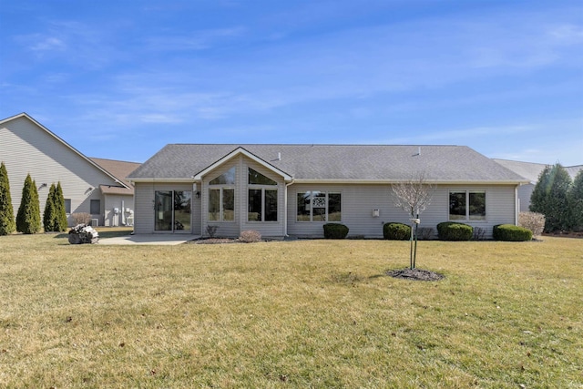 back of property with a yard and a patio