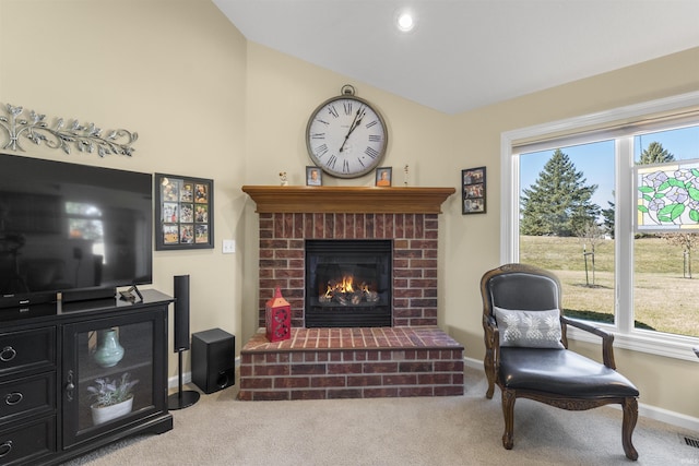 carpeted living room featuring vaulted ceiling, a brick fireplace, visible vents, and baseboards