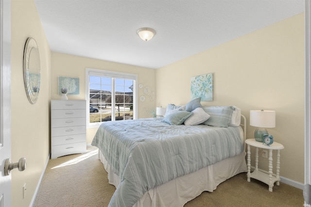 carpeted bedroom with baseboards