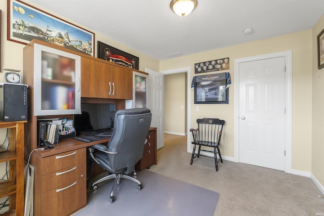 office with light carpet and baseboards