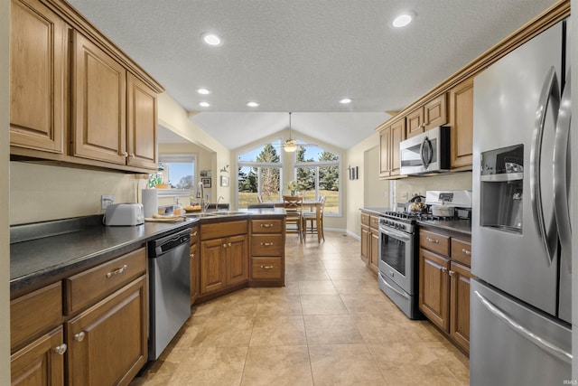 kitchen with dark countertops, lofted ceiling, light tile patterned floors, brown cabinetry, and stainless steel appliances