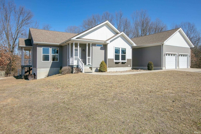 view of front facade featuring a front lawn, a porch, an attached garage, and a shingled roof