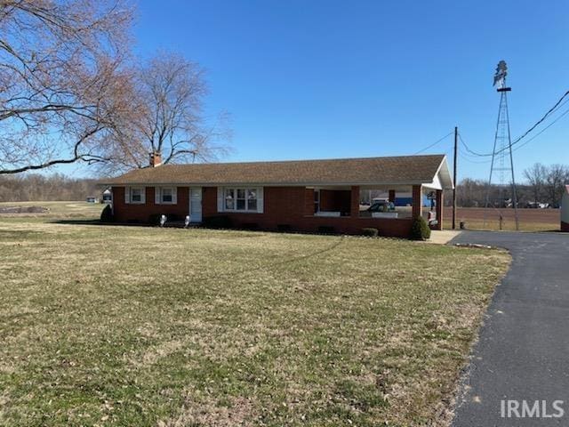 ranch-style home with a front lawn