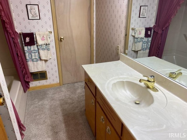 full bathroom with visible vents, wallpapered walls, vanity, and baseboards