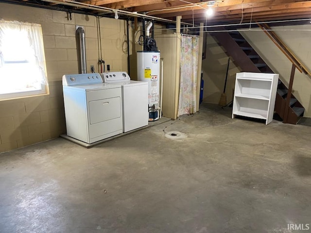 basement featuring gas water heater, stairs, and washer and clothes dryer