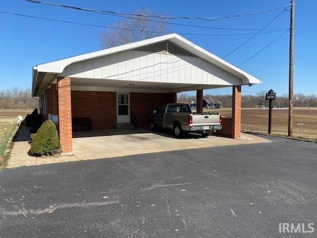 view of parking / parking lot featuring aphalt driveway