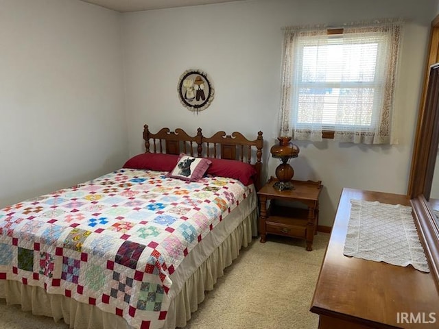 bedroom featuring light colored carpet